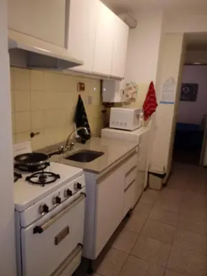 a kitchen with a white stove and a sink at hermoso Dpto. sobre La cañada en el centro de Córdoba capital-Argentina in Cordoba