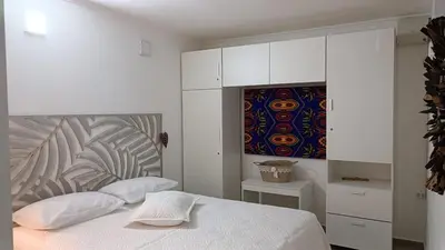 a bedroom with a bed and a painting on the wall at AA Departamento Flat Premium Córdoba in Cordoba
