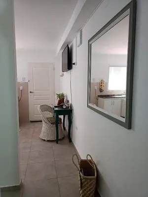 a mirror on a wall in a room with a table at AA Departamento Flat Premium Córdoba in Cordoba