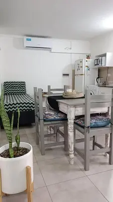 a kitchen with a table and chairs and a plant at AA Departamento Flat Premium Córdoba in Cordoba