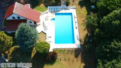 an overhead view of a house with a large swimming pool at Cabañas Stein Weiss in Santa Rosa de Calamuchita