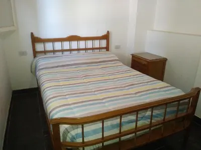 a bed with a striped mattress in a room at Casa de Vacaciones in Santa Rosa de Calamuchita