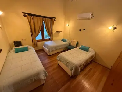 a room with two beds and a window at La Morada, imperdible Casa de Campo en La Matilde in San Javier