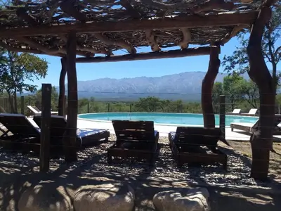 a view of a pool with chairs and a pergola at La Morada, imperdible Casa de Campo en La Matilde in San Javier