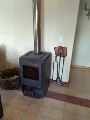 a stove in the corner of a room at La Morada, imperdible Casa de Campo en La Matilde in San Javier