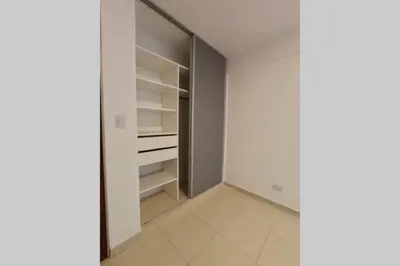 a walk in closet with white walls and white tile floors at Descanso El Parque depto 420 in Cordoba