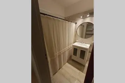 a bathroom with a shower curtain and a sink at Descanso El Parque depto 420 in Cordoba