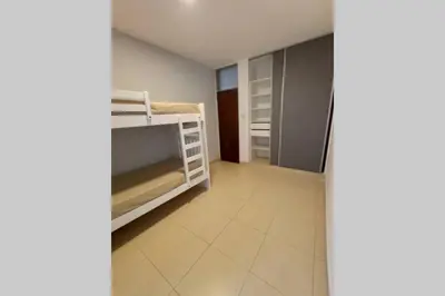 a small room with bunk beds and a hallway at Descanso El Parque depto 420 in Cordoba