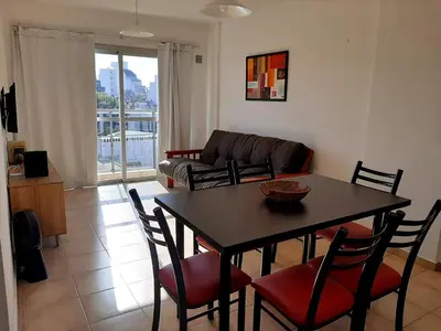a living room with a table and chairs and a couch at Plaza Rivadavia Departamento in Cordoba