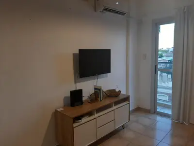 a living room with a flat screen tv on a wall at Plaza Rivadavia Departamento in Cordoba