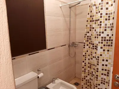 a small bathroom with a toilet and a shower at Plaza Rivadavia Departamento in Cordoba