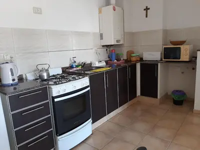 a kitchen with a black and white stove top oven at Plaza Rivadavia Departamento in Cordoba