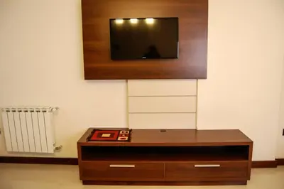 a living room with a tv on a wall at Departamentos Premium Miralejos 3 in Villa Carlos Paz