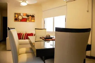 a living room with a table and a couch at Departamentos Premium Miralejos 3 in Villa Carlos Paz