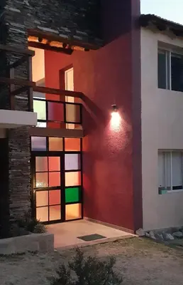 a house with a colorful wall with a fire escape at COSTA COM Apart Suites in Merlo