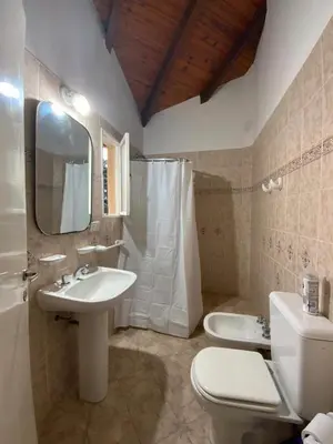 a bathroom with a sink and a toilet and a mirror at condominio La Inesita in Villa Carlos Paz