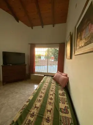 a living room with a television and a rug on the floor at condominio La Inesita in Villa Carlos Paz