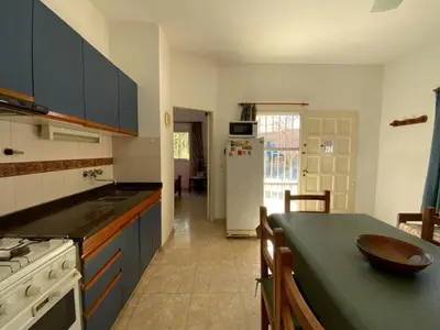 a kitchen with a counter top and a refrigerator at condominio La Inesita in Villa Carlos Paz