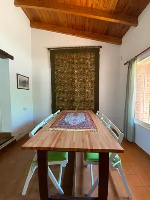 a dining room with a wooden table and chairs at condominio La Inesita in Villa Carlos Paz