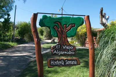 a sign for azazona with a tree on it at El Viejo Algarrobo - Hosteria Serrana in Merlo