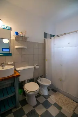 a bathroom with a toilet and a sink at El Viejo Algarrobo - Hosteria Serrana in Merlo