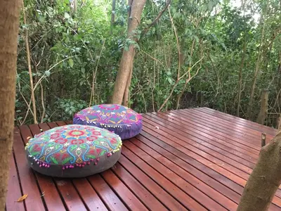 two purple stools sitting on a wooden deck at Monte in Los Manantiales