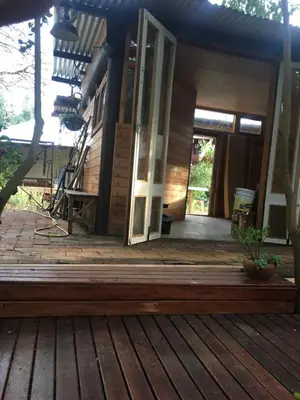 an open door of a house with a deck at Monte in Los Manantiales