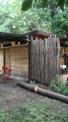 a wooden fence next to a house with a shed at Monte in Los Manantiales