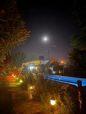 a pool at night with lights next to it at Apart Cabañas Oasis del Valle in Villa Cura Brochero