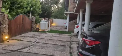 a car parked in the driveway of a house at Apart Cabañas Oasis del Valle in Villa Cura Brochero