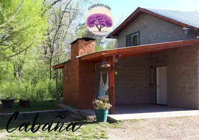 a house with a sign that reads calander at Cabañas Kiri in Santa Rosa de Calamuchita