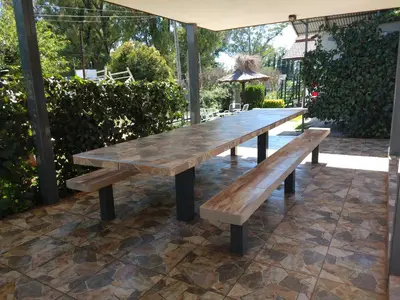 a wooden table and benches on a patio at La posta del vasco in Tanti
