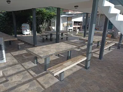 a group of picnic tables on a patio at La posta del vasco in Tanti