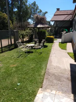 a yard with a table and chairs and an umbrella at La posta del vasco in Tanti