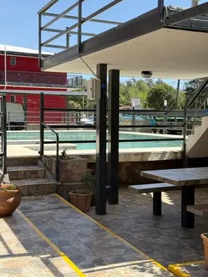 a swimming pool with a picnic table and a bench at La posta del vasco in Tanti