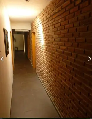 a brick hallway with a brick wall and a hallwayngth at Hotel Posada Del Lago in Villa Carlos Paz