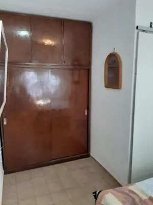 a brown garage door in a room with a bed at Dto Marian Dean funes 2515 Alto Alberdi in Cordoba