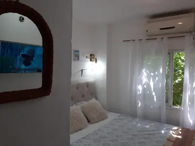 a bedroom with a bed and a mirror and a window at Dto Marian Dean funes 2515 Alto Alberdi in Cordoba