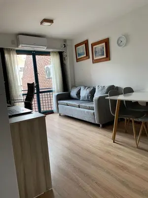 a living room with a couch and a table at Salguero Residential Apartament in Cordoba