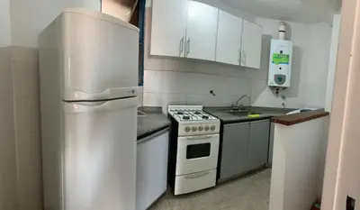 a kitchen with a white stove and a refrigerator at Salguero Residential Apartament in Cordoba