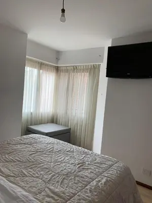 a bedroom with a bed and a flat screen tv at Salguero Residential Apartament in Cordoba