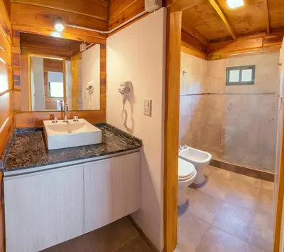 a bathroom with a sink and a toilet at Monviso - Casas de montaña in Santa Rosa de Calamuchita