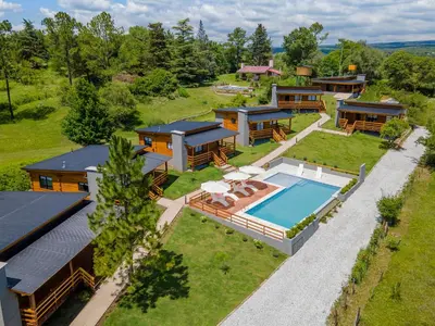 an aerial view of a house with a swimming pool at Monviso - Casas de montaña in Santa Rosa de Calamuchita