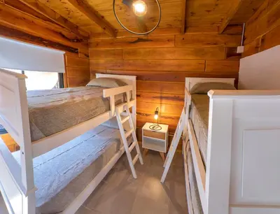 a room with two bunk beds in a cabin at Monviso - Casas de montaña in Santa Rosa de Calamuchita