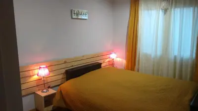 a bedroom with a bed with two lamps on it at Abuelito dime tu in Mina Clavero