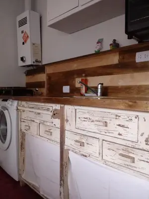a kitchen with a sink and a washing machine at Abuelito dime tu in Mina Clavero
