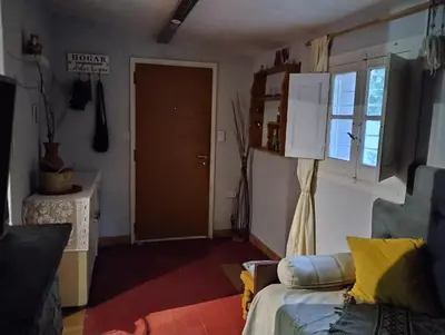 a living room with a couch and a door at Abuelito dime tu in Mina Clavero