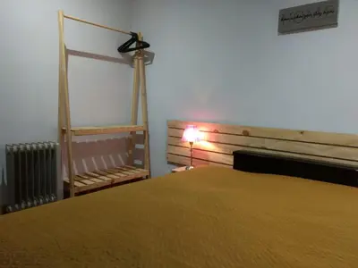 a bedroom with a bed and a lamp next to a radiator at Abuelito dime tu in Mina Clavero