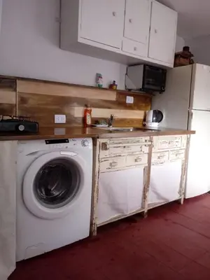 a kitchen with a washing machine and a sink at Abuelito dime tu in Mina Clavero