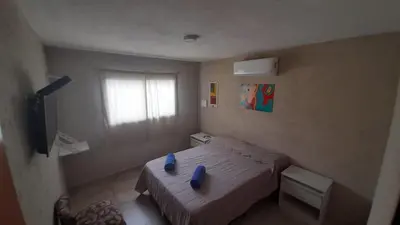 a bedroom with a bed with blue pillows on it at SIMION in Villa Carlos Paz
